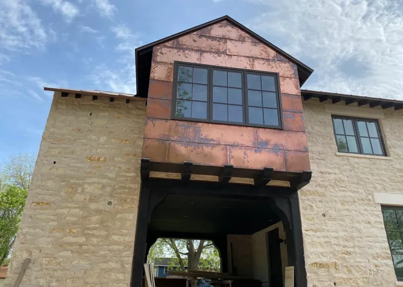 Copper metal panel facade on a stone building for Skylight Installation in Manheim